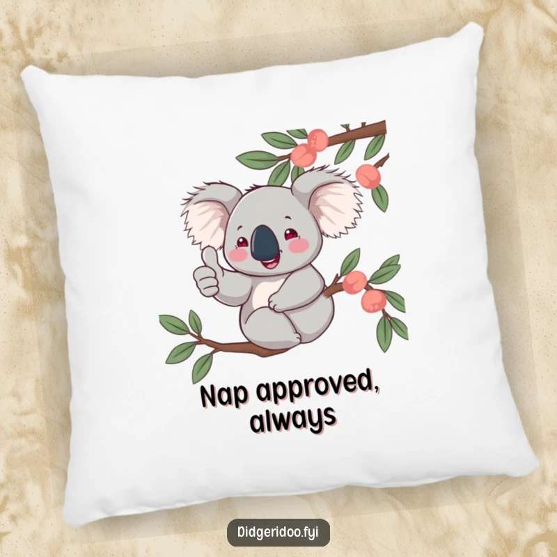 Funny, jovial koala character giving a thumbs up from a eucalyptus branch, pictured on a soft pillow for decorative comfort and positivity.