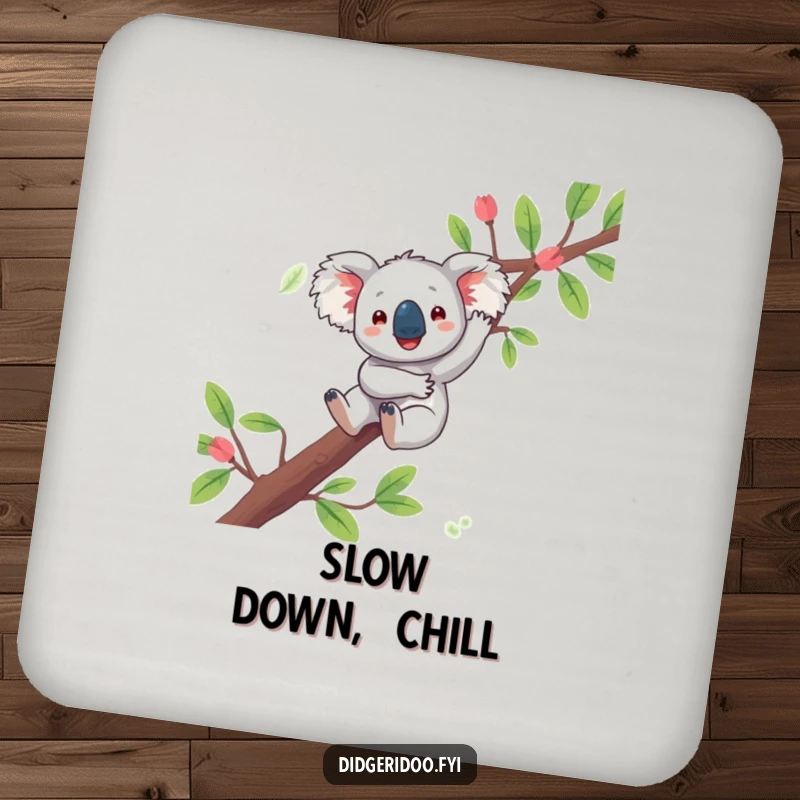 Funny koala drink coaster featuring a playful character joyfully dangling from a eucalyptus branch, offering surface protection with Aussie charm.