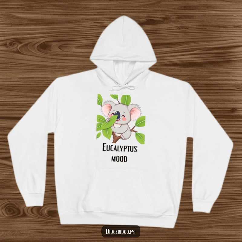 Funny koala hoodie, smiling and balancing a eucalyptus leaf on its nose, offering warmth and a dose of calm, cute humor.