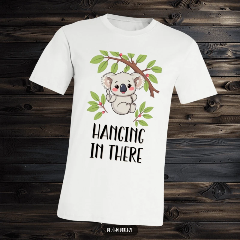 Funny Koala Thumbs Up T-Shirt: A cute, blushing koala hanging from a eucalyptus branch, giving a positive thumbs up gesture.