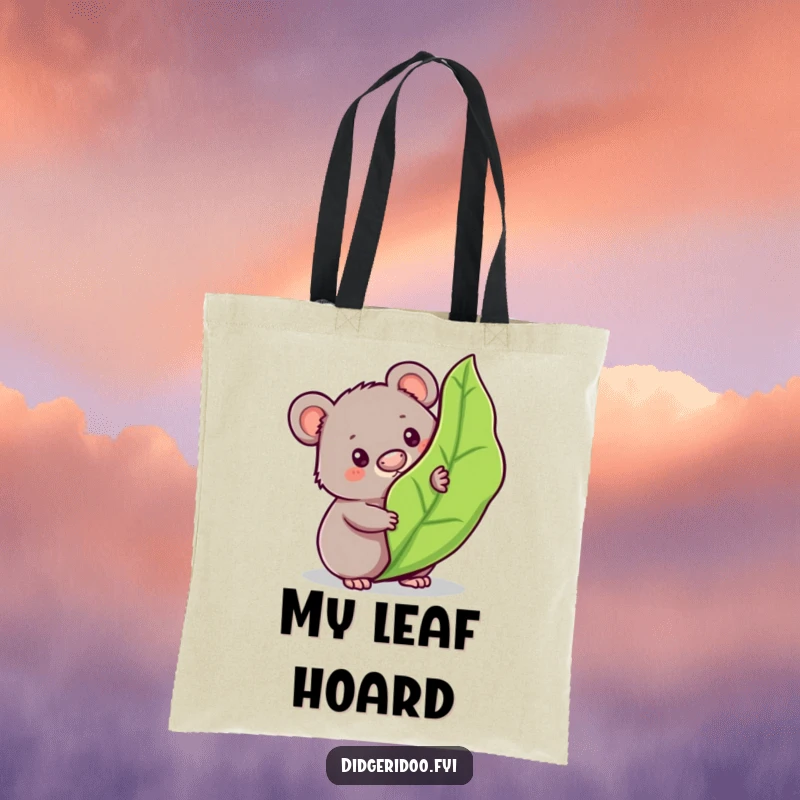 Funny wombat tote bag showcasing a curious character peeking from behind a bouncy gum leaf, perfect for everyday use with charm.